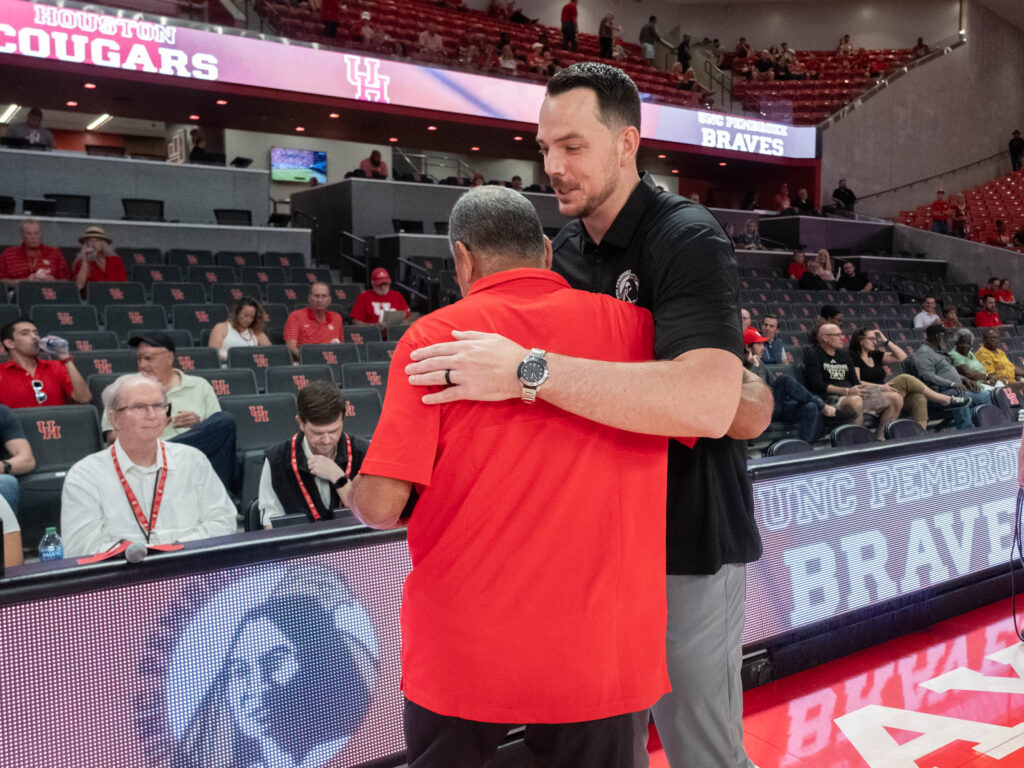University of Houston head coach Kelvin Sampson and UNC Pembroke coach Drew Richards shared a moment. (Photo by F. Carter Smith)