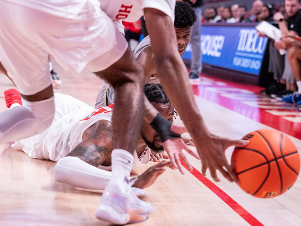 Diving on the floor for loose balls is a requisite for UH players. Exhibition game or not. (Photo by F. Carter Smith)