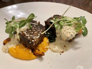 Crazy – Beef short rib draped with both a sesame garlic crumble as well as a punchy pickled mustard butter sauce. (Photo by Courtney Dabney)