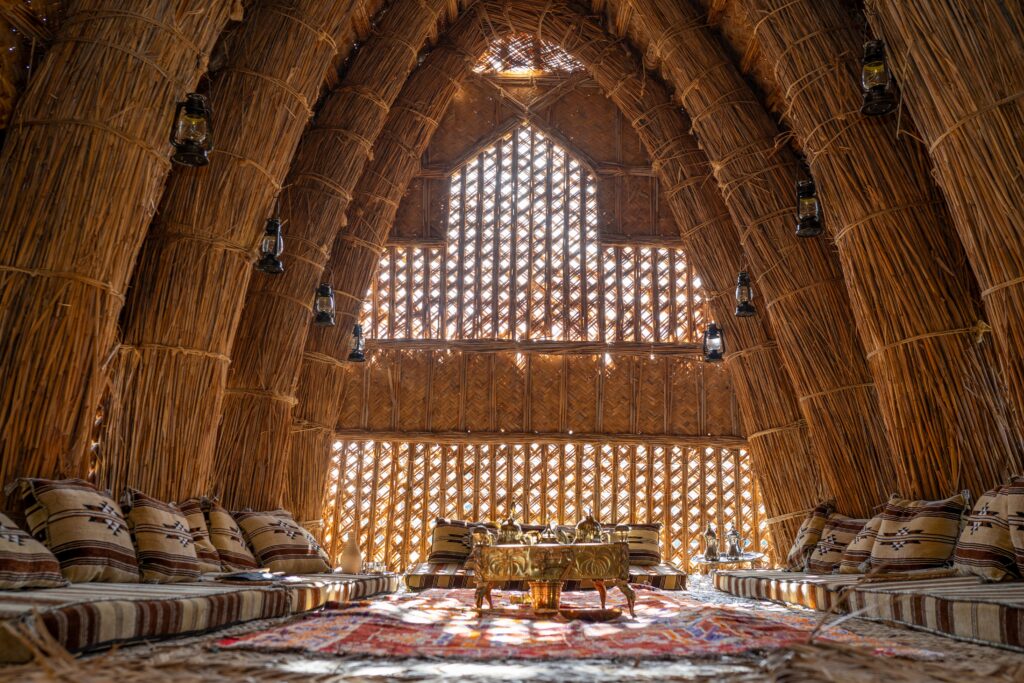 Inside the mudhif is decorated with beautifully designed couches, rugs, and decorations for visitors to enjoy coffee and Iraqi snacks during their open houses. (Photo by Henrich Perez)