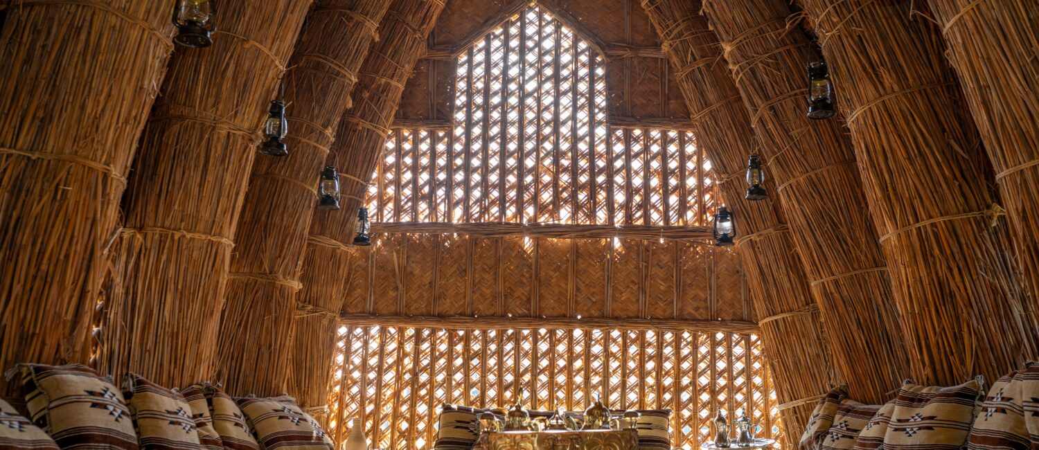 Inside the mudhif is decorated with beautifully designed couches, rugs, and decorations for visitors to enjoy coffee and Iraqi snacks during their open houses. (Photo by Henrich Perez)