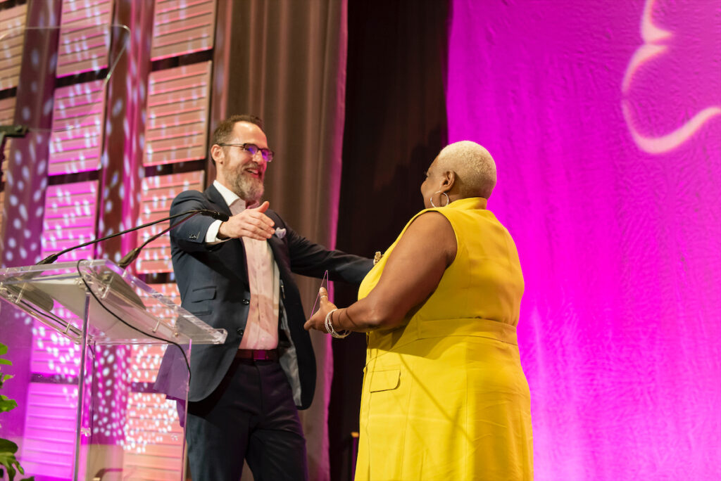 Mike Howard accepts his surprise ProtectHER Award from Annette Bailey (Photo by Tamytha Cameron and Celeste Cass)
