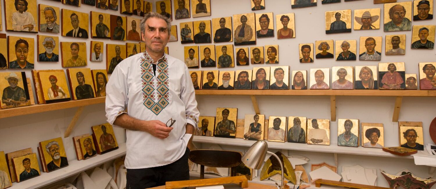 Artist Nestor Topchy appears in his studio next to artworks featured in his solo exhibit "The Iconic Portrait Strand," which remains on view through January 21, 2024 at The Menil Collection. (Photo by Caroline Philippone. Courtesy The Menil Collection)