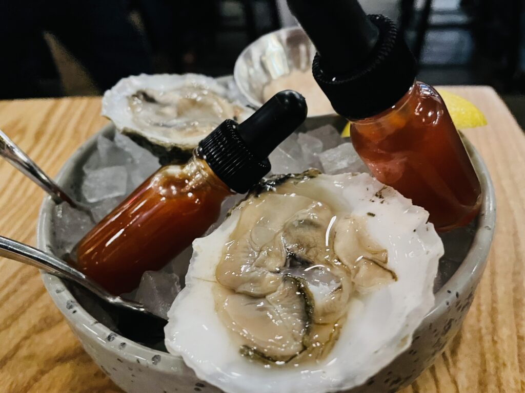 A starter of Pink Lady oysters at Plank Seafood Provisions. (Photo by Courtney Dabney)
