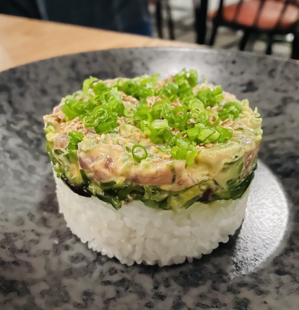 Tuna poke resting atop silken seaweed salad and sticky rice. (Photo by Courtney Dabney)