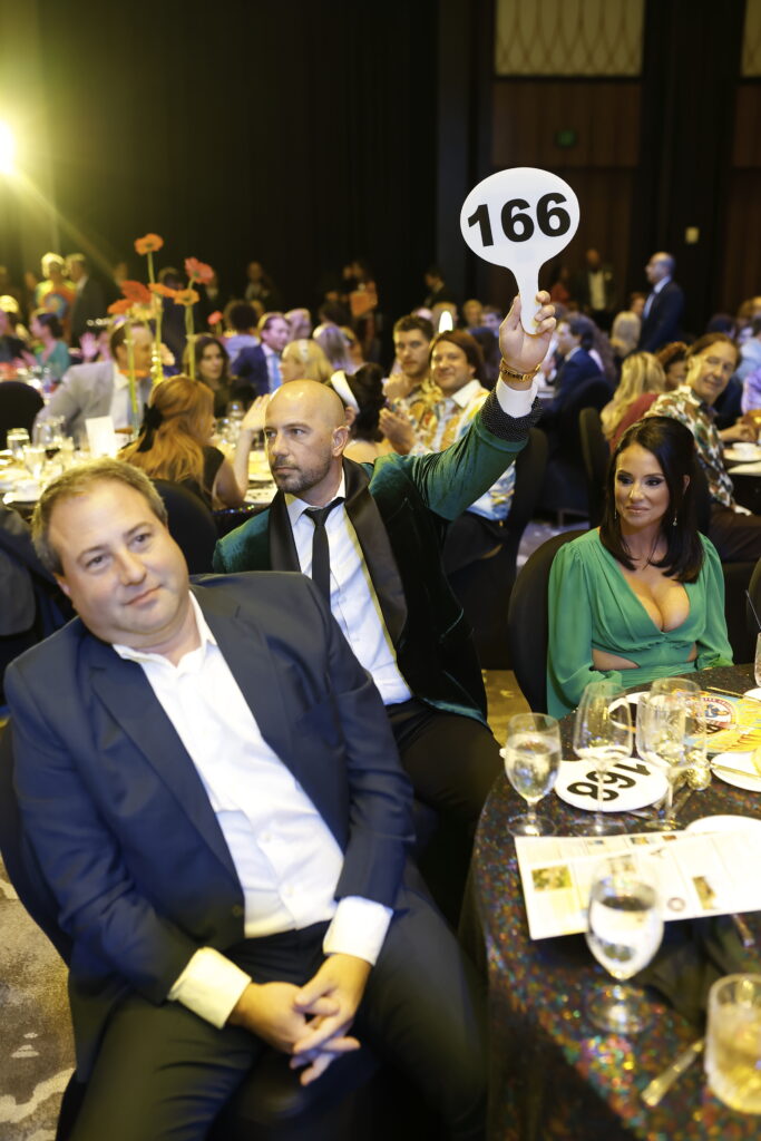 Brandon Dewan is high bidder on the Italy wine trip at the Houston Children's Charity Gala (Photo by Quy Tran)