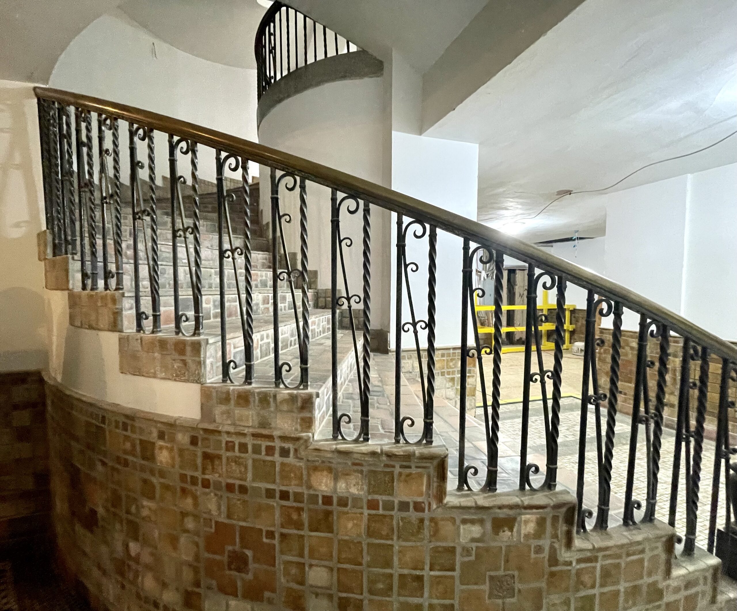 The Baker – The spiral staircase leading to the lobby fitted with its original wrought iron and tile work. (Photo by Courtney Dabney)