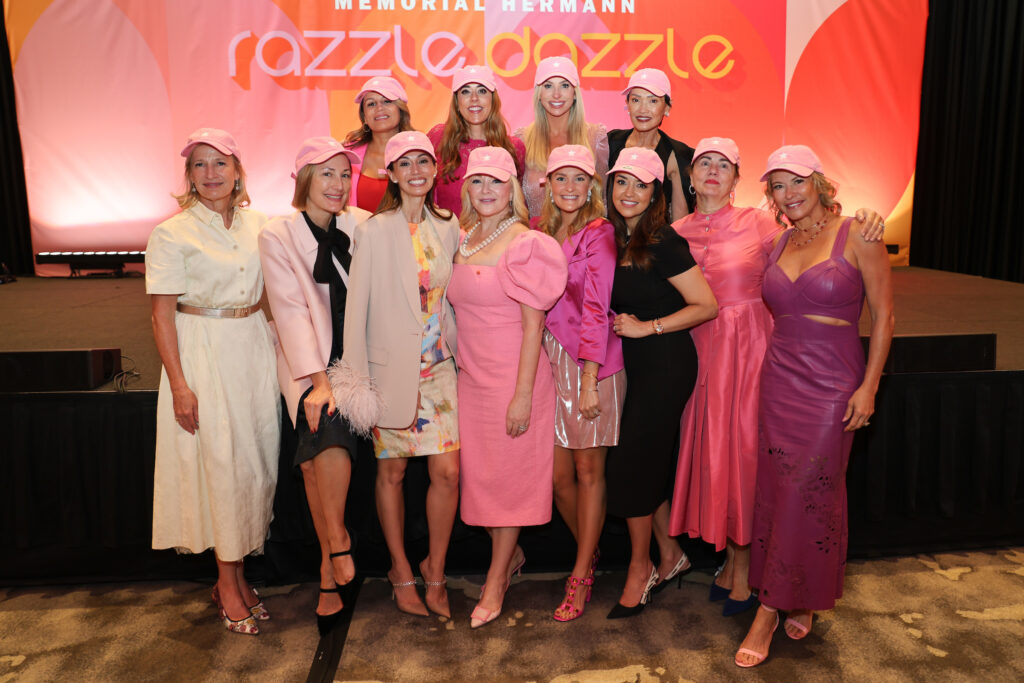 Pink Astros caps, a gift from Whitney & Jim Crane, are a hit with guests at Memorial Hermann Foundation's Razzle Dazzle luncheon (Photo by Priscilla Dickson)