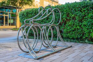 Three riders are represented in the "Faith, Hope and Love" bike rack from artist Robert Heintzelman. (Photo by Joan Tilton)