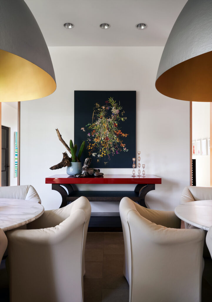 In the dining room, the large dome pendants are by Ingo Maurer. The console is Christian Liaigre. Stephen Eichhorn artwork from Carrie Seacrest Gallery, Chicago. (Photo by Pär Bengtsson)