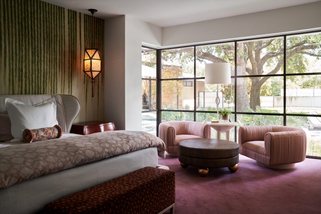 In the main bedroom, a Fortuny lantern and de Gournay wallpaper. On the Giorgetti bed are
a custom pillow in Dedar fabric and Ann Gish coverlet. Natasha Baradaran lounge chairs. John Dickinson table. Christian Liaigre floor lamp. (Photo by Pär Bengtsson)