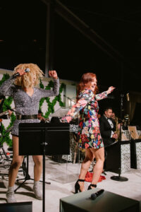 Julia Morales Clark joins Tulani on stage at Children's Memorial Hermann Hospital 'Fare La Fête' gala in Memorial Park. (Photo by Joseph West)