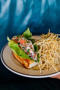 The lobster roll — likely to be the menu’s most Instagrammable dish — is built on a cushy buttered and toasted bun, the meat brushed with drawn butter, layered with bibb lettuce, accented with lemon aioli, and served with a pile of crisp, matchstick-thin French fries ($39). (Photo by Justin Book)