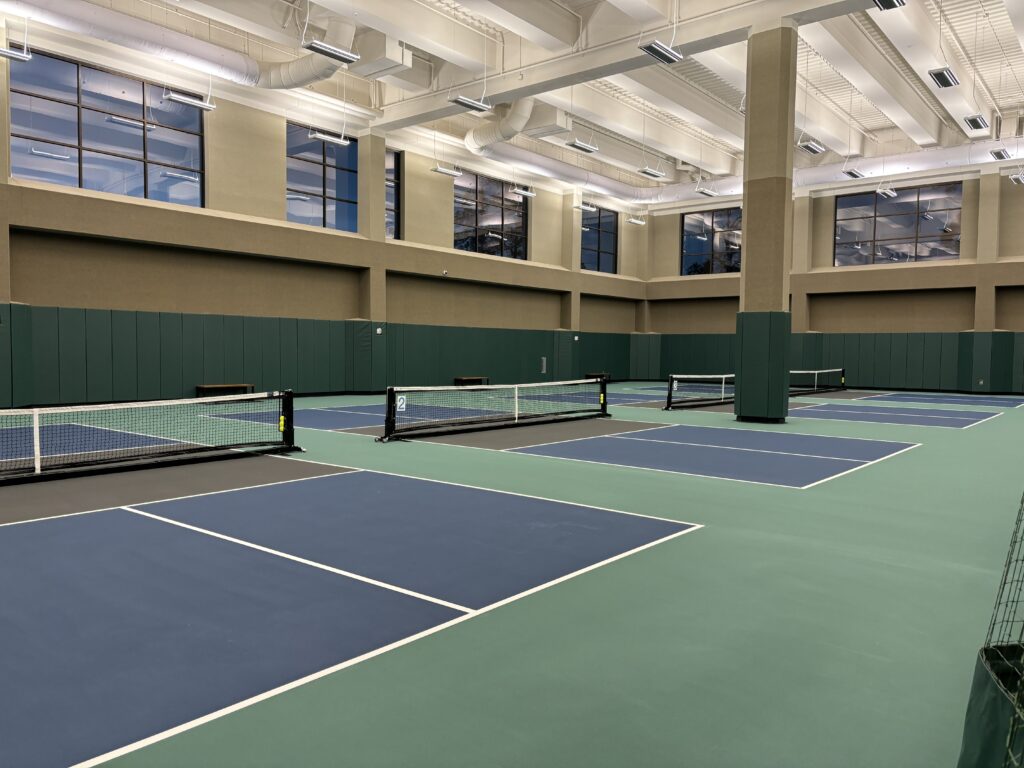 There are five indoor pickle ball courts, and a large area for spectators and groups near the courts.