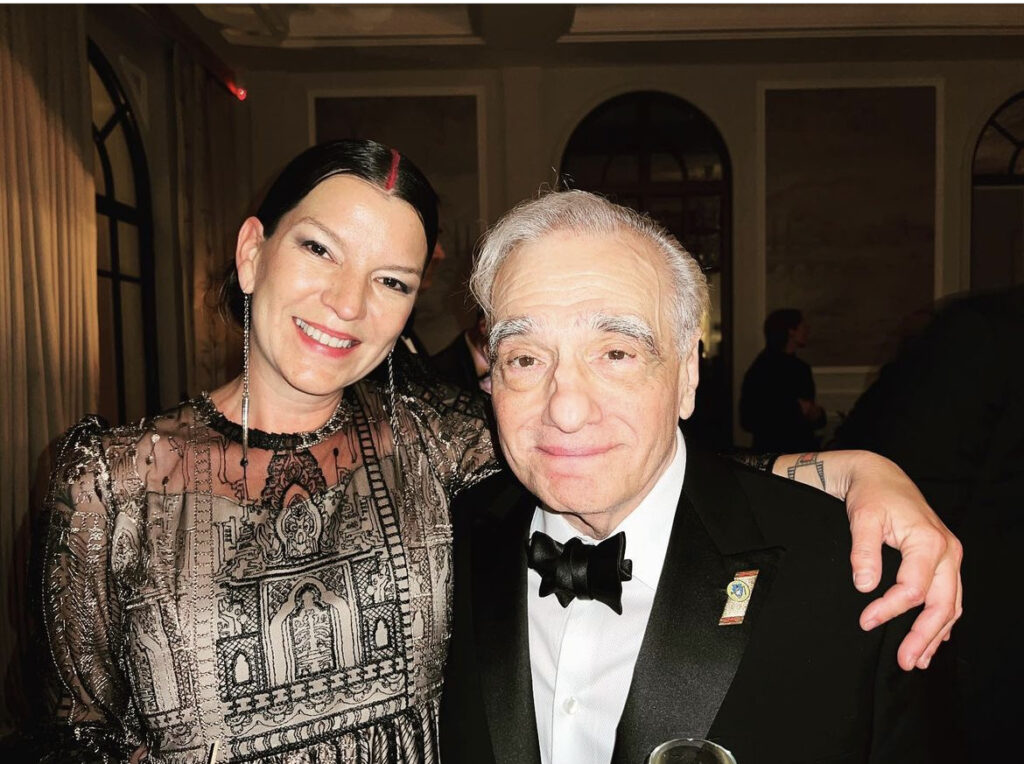 "Killers of the Flower Moon" Assistant Art Director Addie Roanhorse celebrating the film's debut with Director Martin Scorsese.
Photo Credit: Addie Roanhorse
