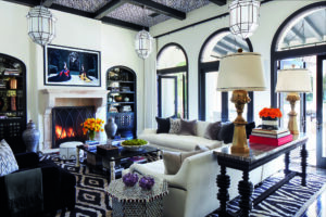 In Khloe Kardashian’s family room, a Patrick Demarchelier artwork raises to reveal a television; fireplace is French 18th century. _0995_F (Photo by Douglas Friedman)