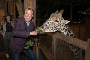 Kevin Sullivan feeding the giraffe (Photo by Thomas Garza and Rob Wythe/Wythe Portrait Studio)