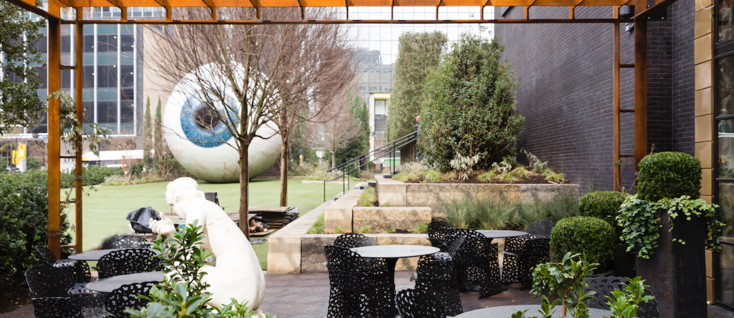 The patio at Forty Five Ten’s Champagne Bar, with landscaping by Hocker Design and a striking view of Tony Tasset’s “Eye” sculpture. (photo by Kurt Griesbach)