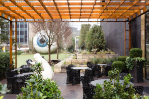 The patio at Forty Five Ten’s Champagne Bar, with landscaping by Hocker Design and a striking view of Tony Tasset’s “Eye” sculpture. (photo by Kurt Griesbach)