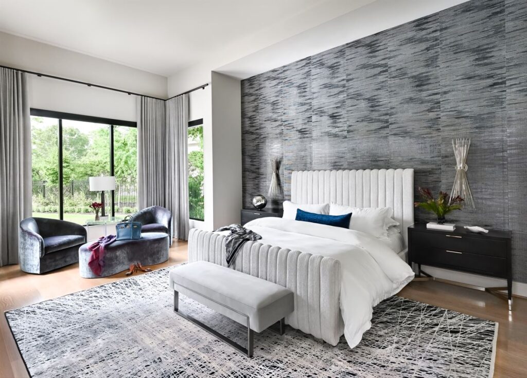 The primary bedroom at this Carlton Woods designer mansion has a light, contemporary feel, with drapery that can close off the room completely.