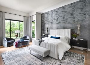 The primary bedroom at this Carlton Woods designer mansion has a light, contemporary feel, with drapery that can close off the room completely.