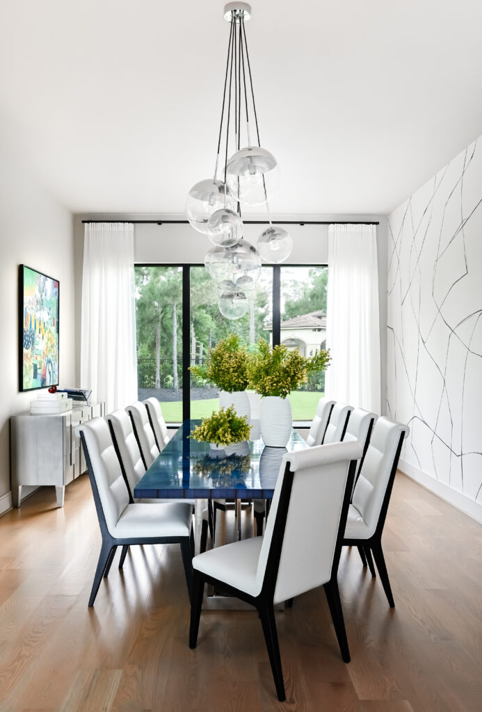 A dining area with sleek lines and a contemporary fixture make for an elegant scene at this Carlton Woods estate.