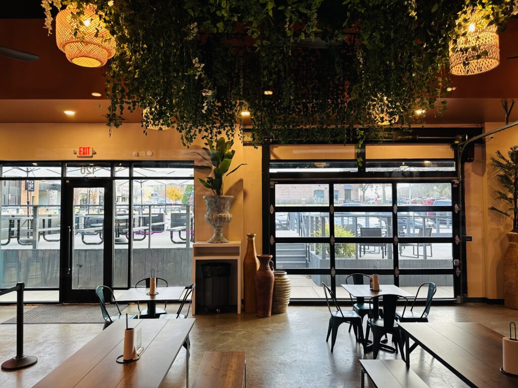 Greenery hangs overhead and garage doors stand a the ready for good weather.