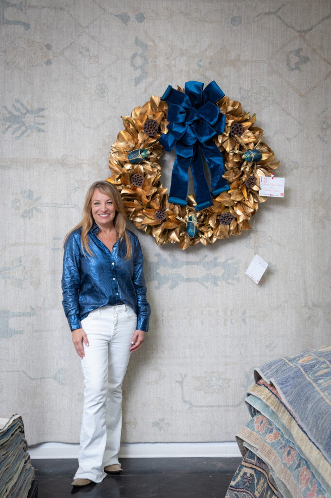 Tami Owen with her wreath at the Turkish Rug Company showroom grand opening party benefiting the Salvation Army.