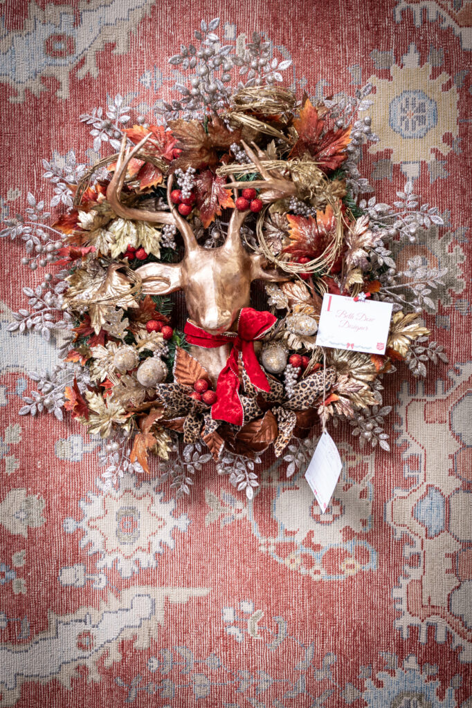 Designer Beth Dow's deer head wreath wins first place at the Turkish Rug Company showroom grand opening party benefiting the Salvation Army.
