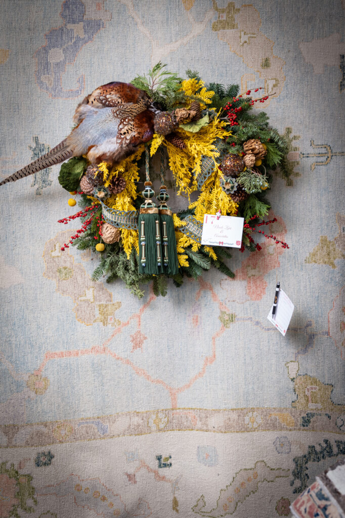 Nicole Zarr's pheasant-focused wreath wins second place at the Turkish Rug Company showroom grand opening party benefiting the Salvation Army.