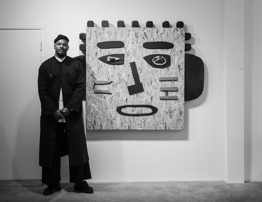 Mr. Tomonoshi poses with his "Bantu Knot Warrior 001," 2023, at Reeves Art + Design (Photo by Jessica Dao (Photo by Jessica Dao)