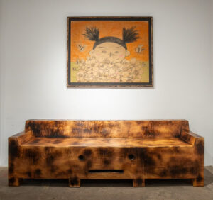 Mr. Tomonoshi’s “A Closer Look” hangs above a Yakisugi “Fun’iture Sofa,” 2023, at Reeves Art + Design (Photo by Jessica Dao)