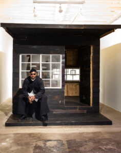 Mr. Tomonoshi with his 15 x 10 foot "Yakisugi Teahouse," 2023, at Reeves Art + Design (Photo by Jessica Dao)