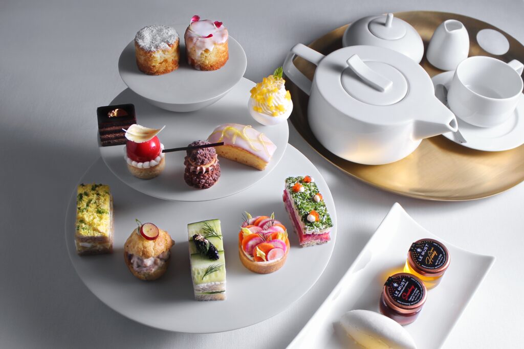 Enjoy a traditional tea service featuring Ikaati hot teas paired with sweet and savory bites.