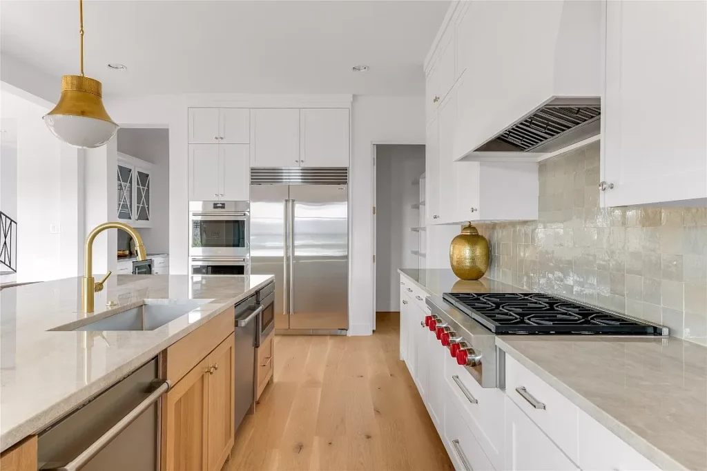 4648 Esprit Lane's kitchen has a butler's pantry with a separate bar and a design mix of metals and woods.