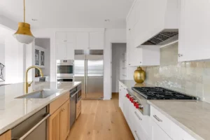 4648 Esprit – The kitchen with a view to the butler’s pantry, separate bar and its mix of metals and woods