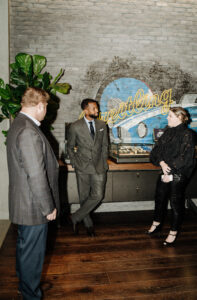 Kellyn Acosta enjoying cocktail hour with guests at the Breitling NorthPark Center boutique (Photo by Afritina Coker)
