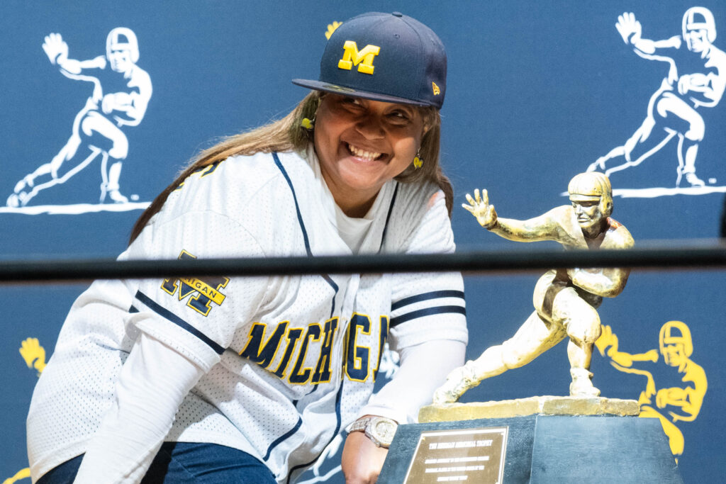 Michigan fans gleeful posed with the Heisman during Houston's big national championship game hosting moment. (Photo by F. Carter Smith)
