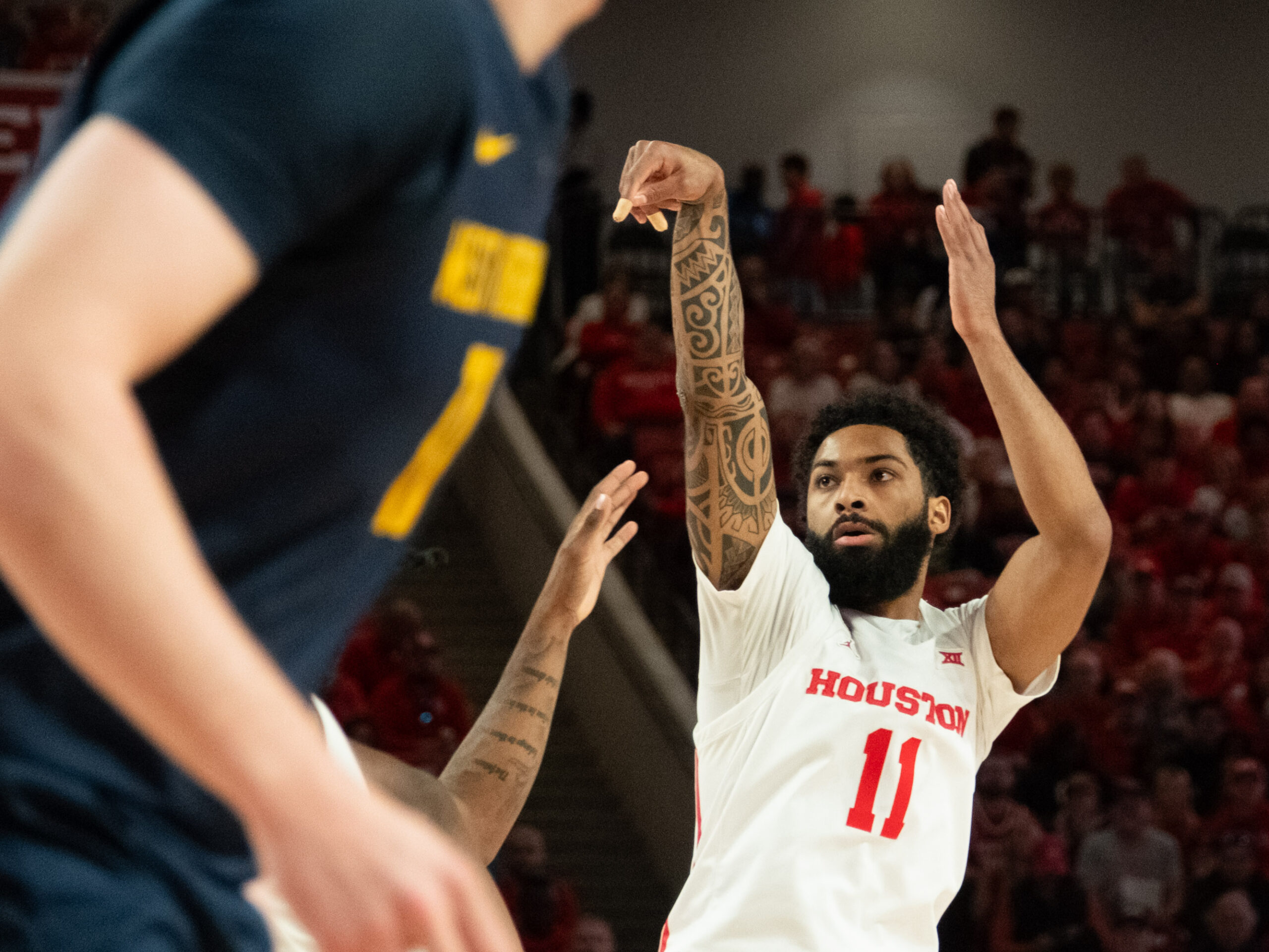 In its first Big XII contest, the University of Houston Cougars beat the University of West Virginia Mountaineers at the Fertitta Center