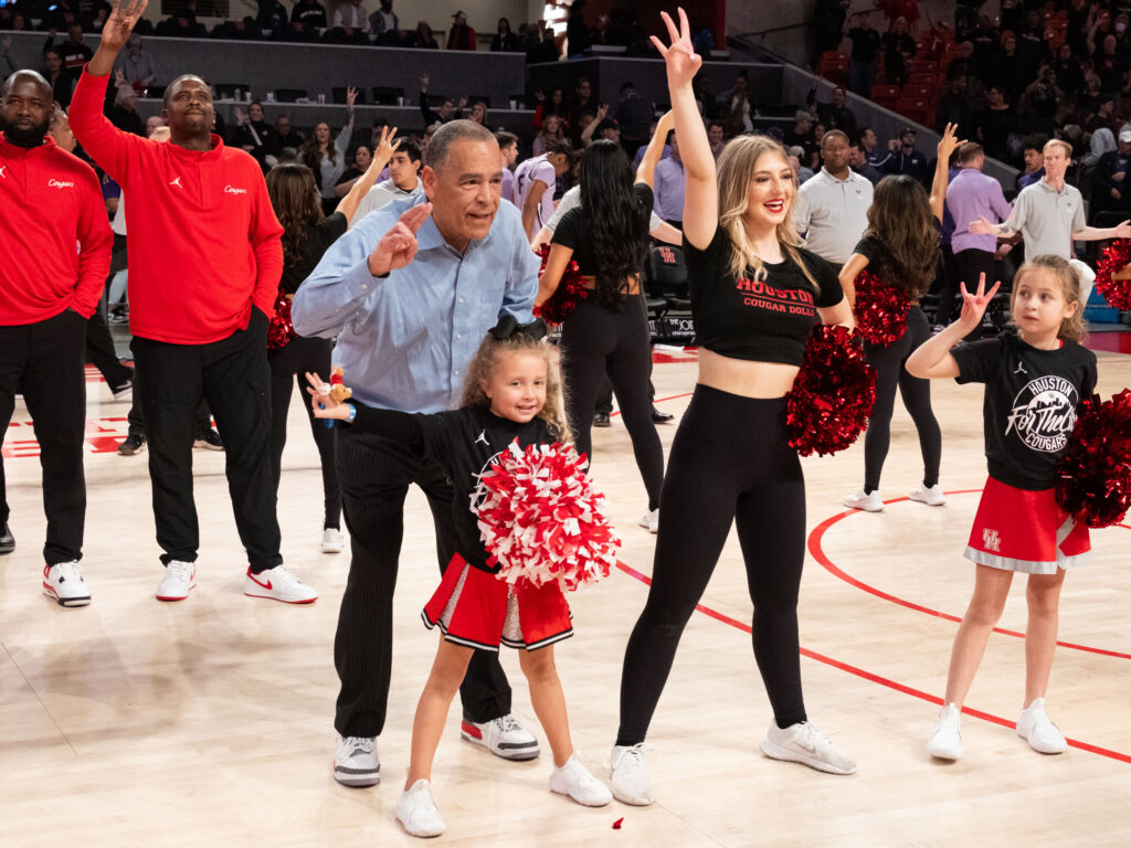 University of Houston coach Kelvin Sampson shared a moment with his cheerleader-loving granddaughter Maisy Jade after a win over Kansas State. (Photo by F. Carter Smith)