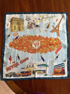 The Brasserie 19 silk scarf features all things French, available only at the River Oaks Shopping Center restaurant.
