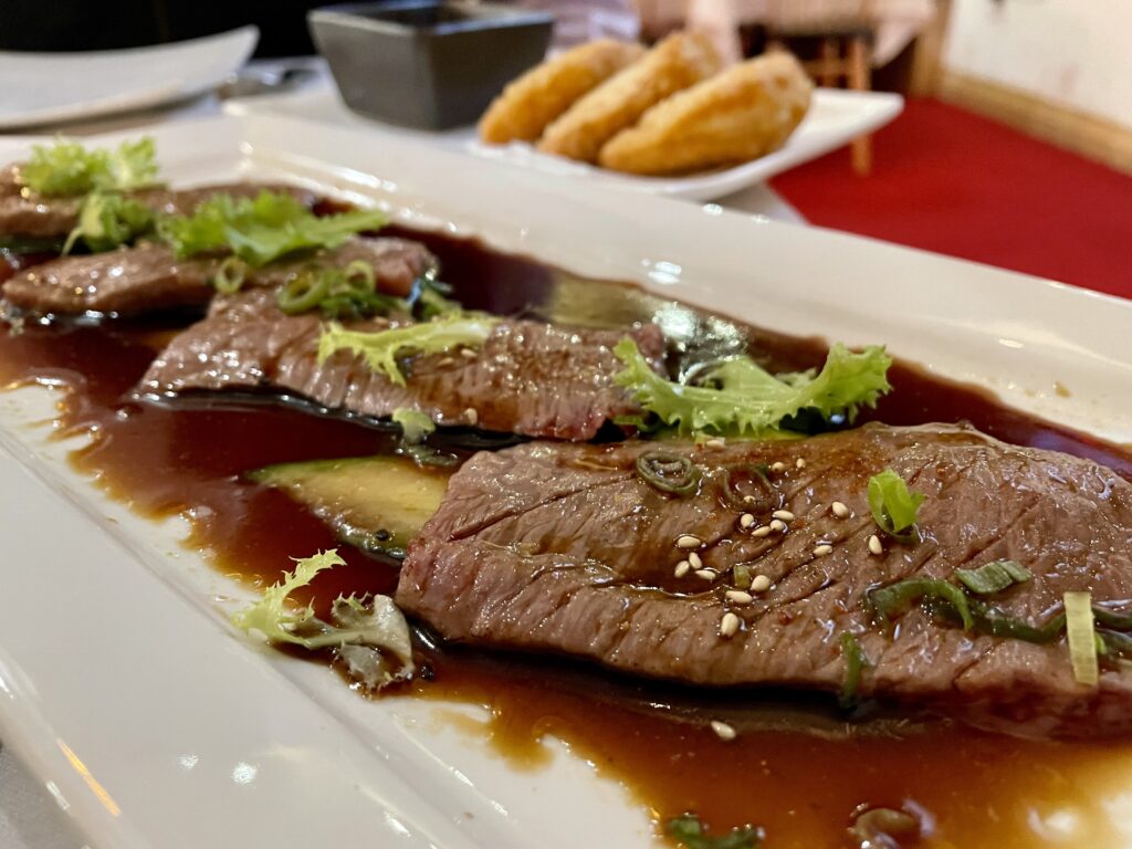 The Kobe carpaccio at Megu is lightly seared A5 Wagyu in a soy broth. (Photo by Courtney Dabney)