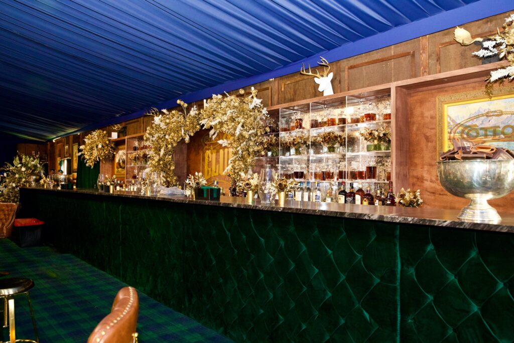 The iconic 50-foot bar in the Cotton Holdings Inc. Cotton 'Q Club at the RodeoHouston barbecue cook-off. (Photo by Ashley Patranella, Painted Peacock Photography)