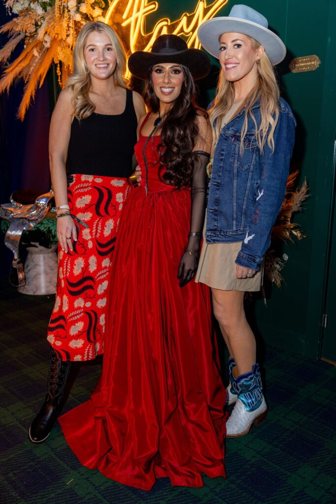 Bailey Bell, Zinat Ahmed in a gown, Whitney Lawson in the Cotton 'Q Club at the RodeoHouston barbecue cook-off. (Photo courtesy of Cotton Holdings Inc.)