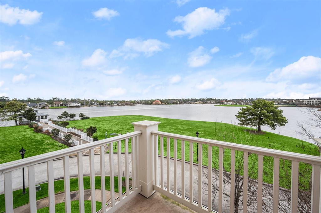 The balcony at 210 Breezy Way overlooks Lake Woodlands.