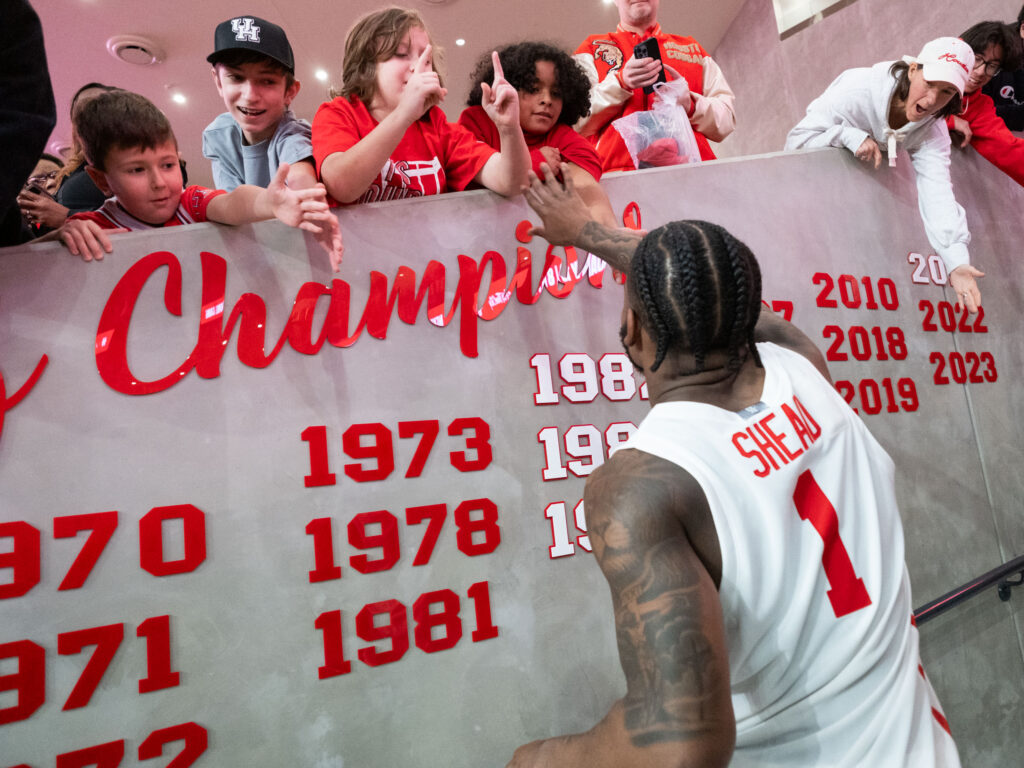 University of Houston point guard Jamal Shead takes time to sign autographs for fans after the game. (Photo by F. Carter Smith)