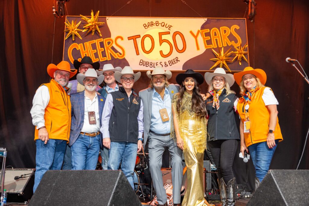 Cotton Holdings Inc. leadership join chairmen of the World's Championship Bar-B-Que Contest in the Cotton 'Q Club. (Photo courtesy of Cotton Holdings Inc.)