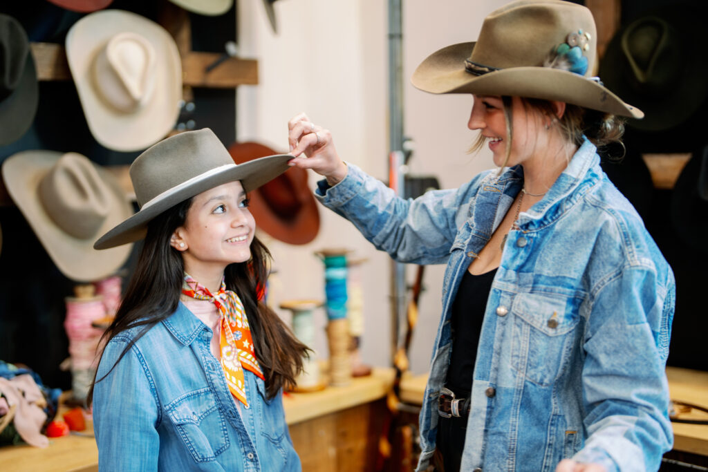 Kamila Almodovar gets a hat fitting at the rodeo bash welcoming the Kemo Sabe pop-up at Nan and Company Properties headquarters. (Photo by Nan Studio)