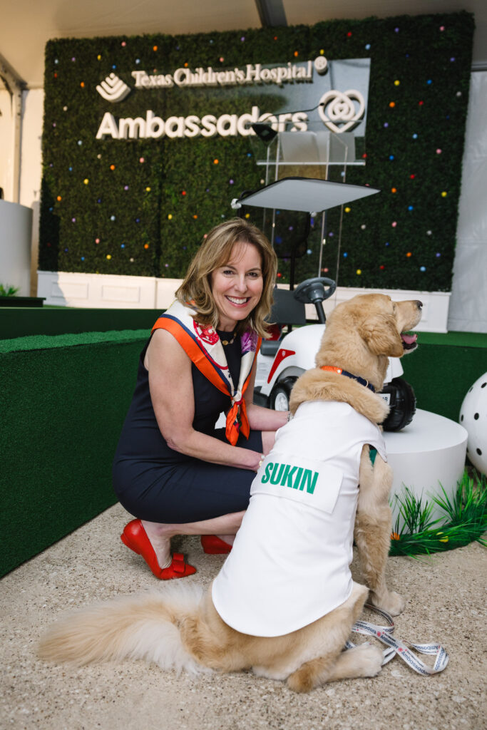 Debbie Sukin with Pawsitive Play “caddie,” Cohen ; Photo courtesy of Texas Children’s Hospital