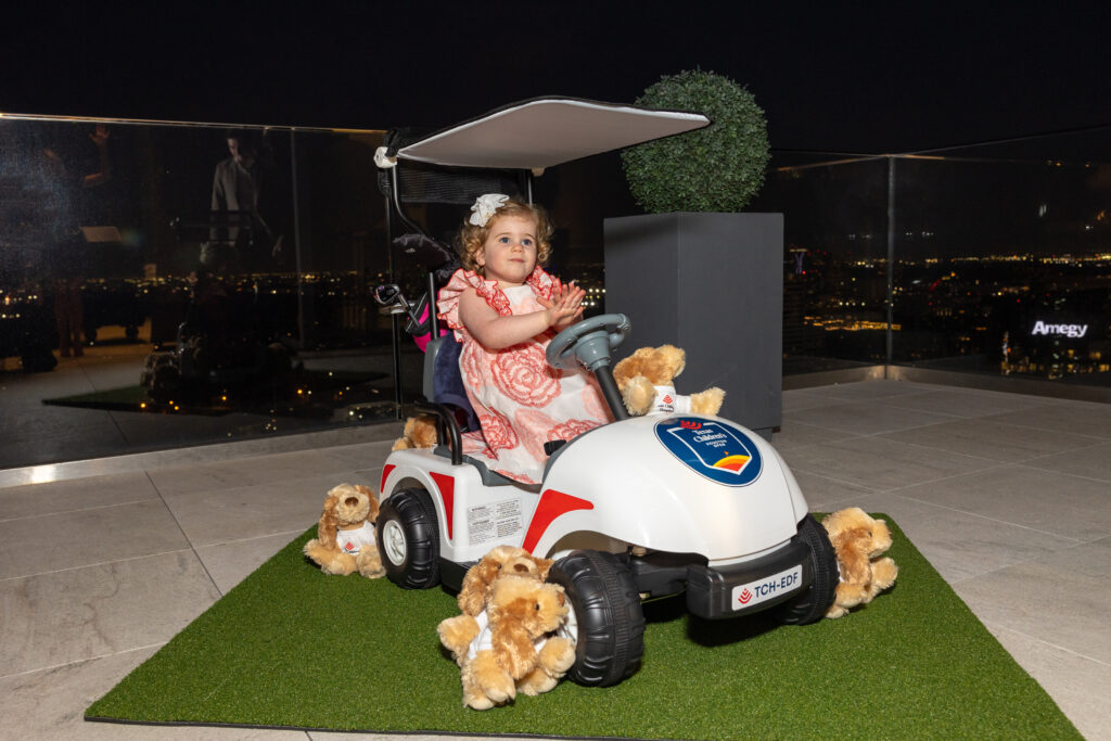 Elle Fertitta in her mini-golf cart with mini-golf clubs at the Texas Children's Houston Open Tee-Off in the penthouse suite at the Post Oak Hotel.  (Photo by Jenny Antill)